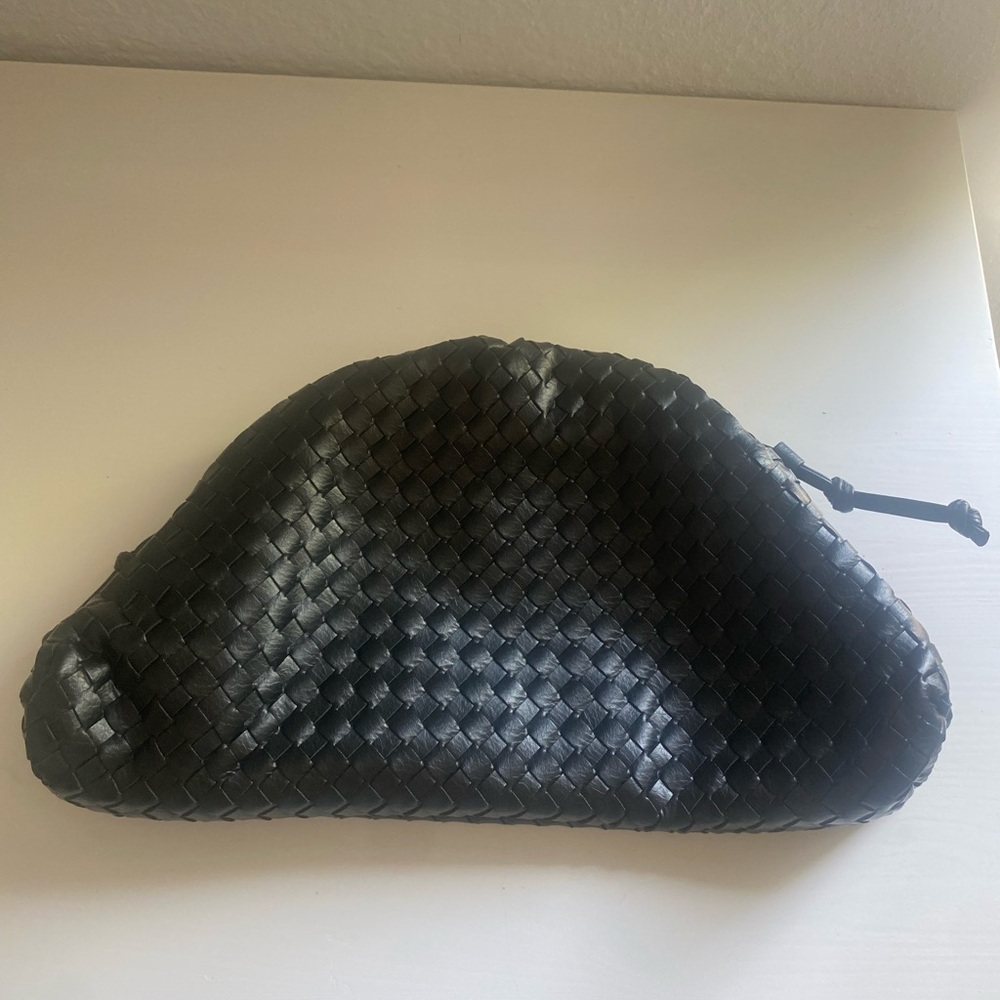 Faux leather woven black pouch bag.